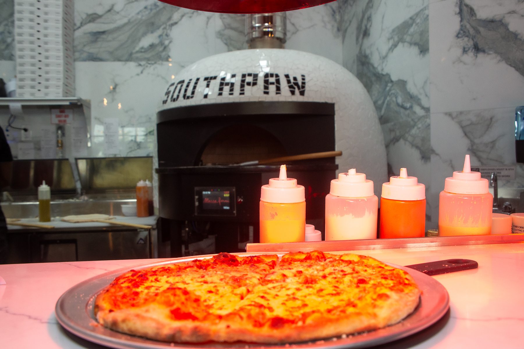 Wood-fired pizza on the peel — West Palm Beach food photography by Concha Solutions
