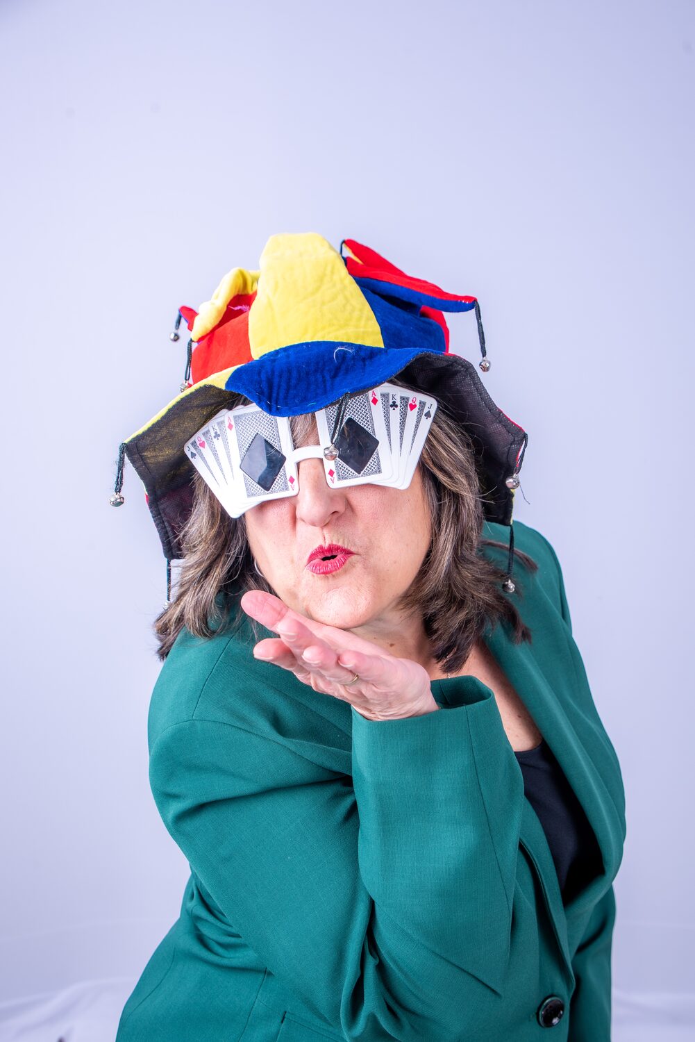 Playful team portrait with jester-hat party props — West Palm Beach headshot photography by Concha Solutions