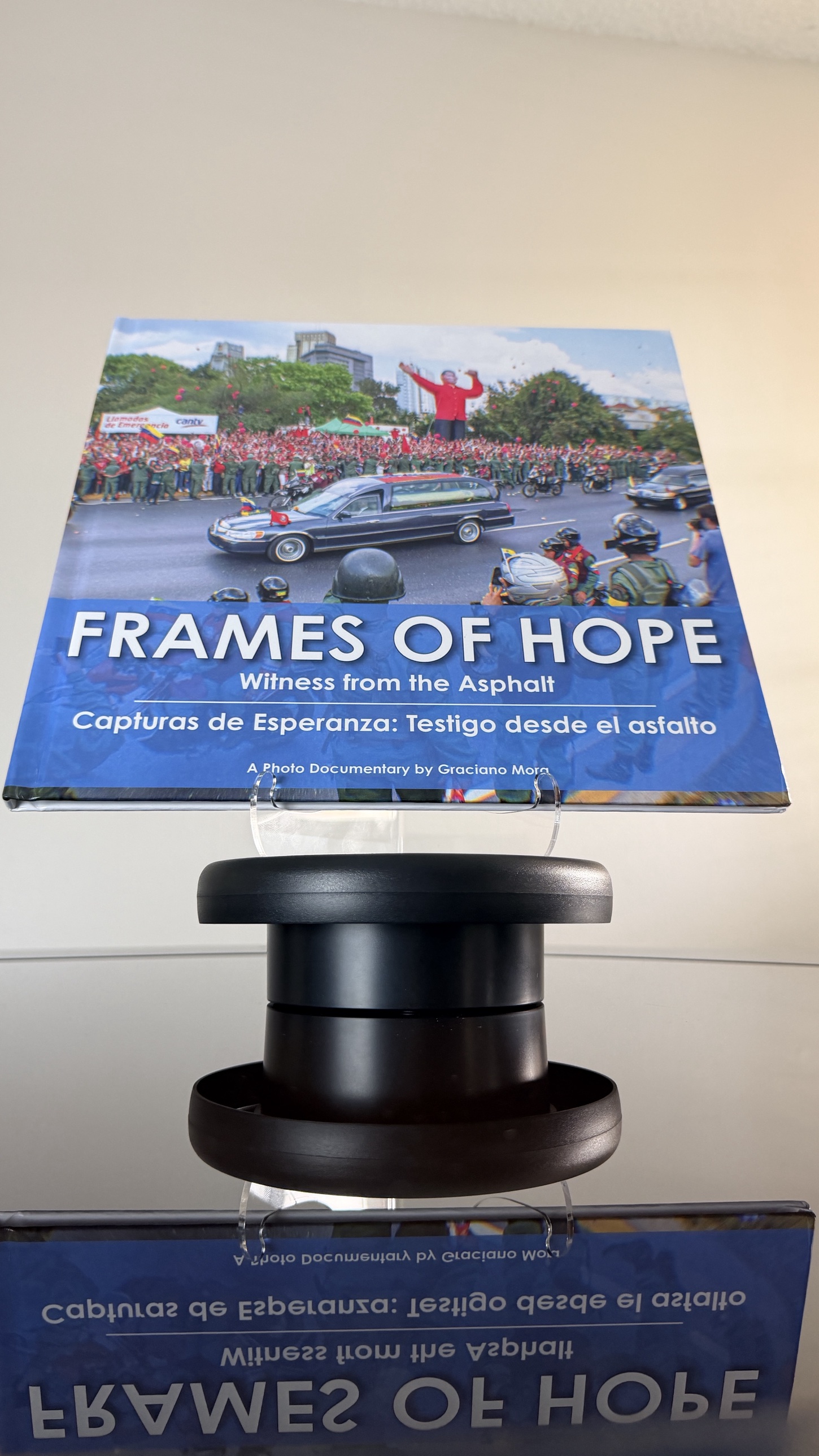 Frames of Hope: Witness from the Asphalt, hardcover photo monograph by Graciano Mora, full cover on display stand